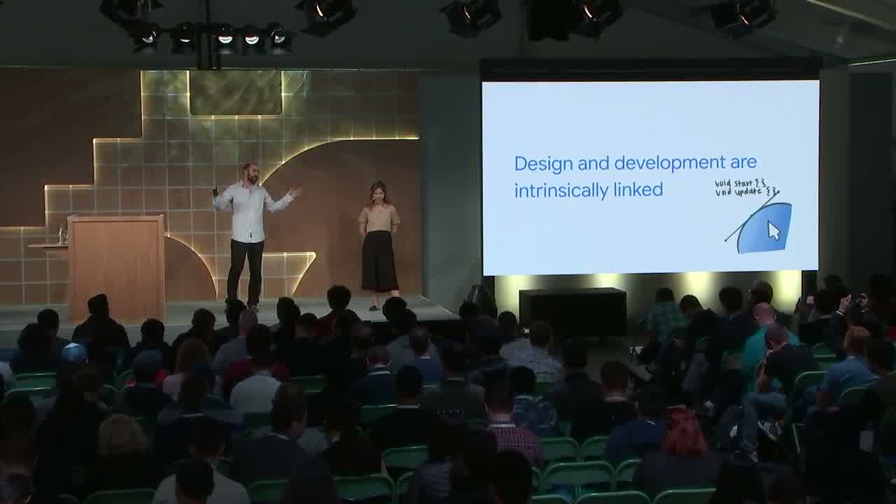 On stage at Google I/O 2019, beside a slide reading 'Design and development are intrinsically linked'
